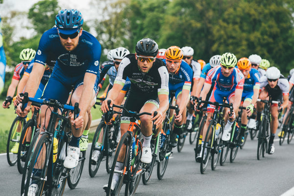 Cycling race with multiple cyclists on a road for brand Ek Sports Nutrtion.